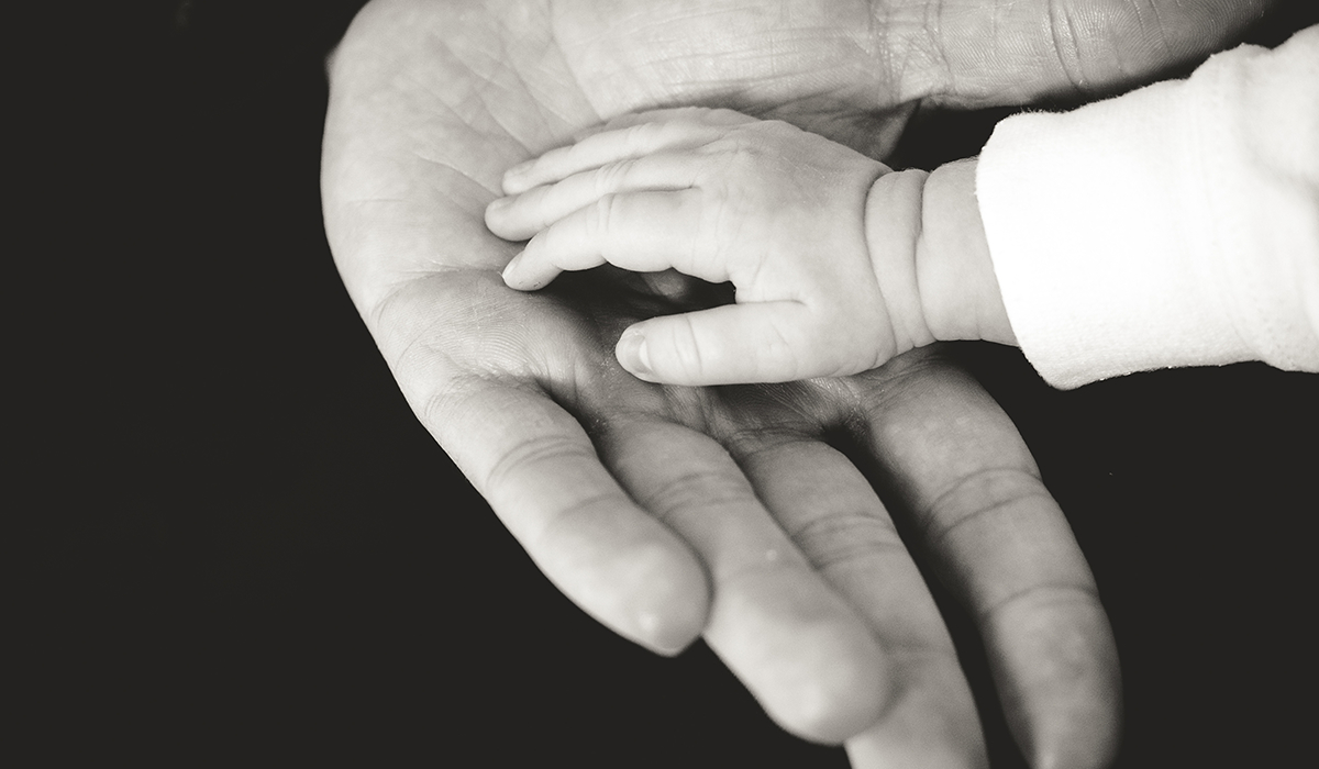 holding baby's hand