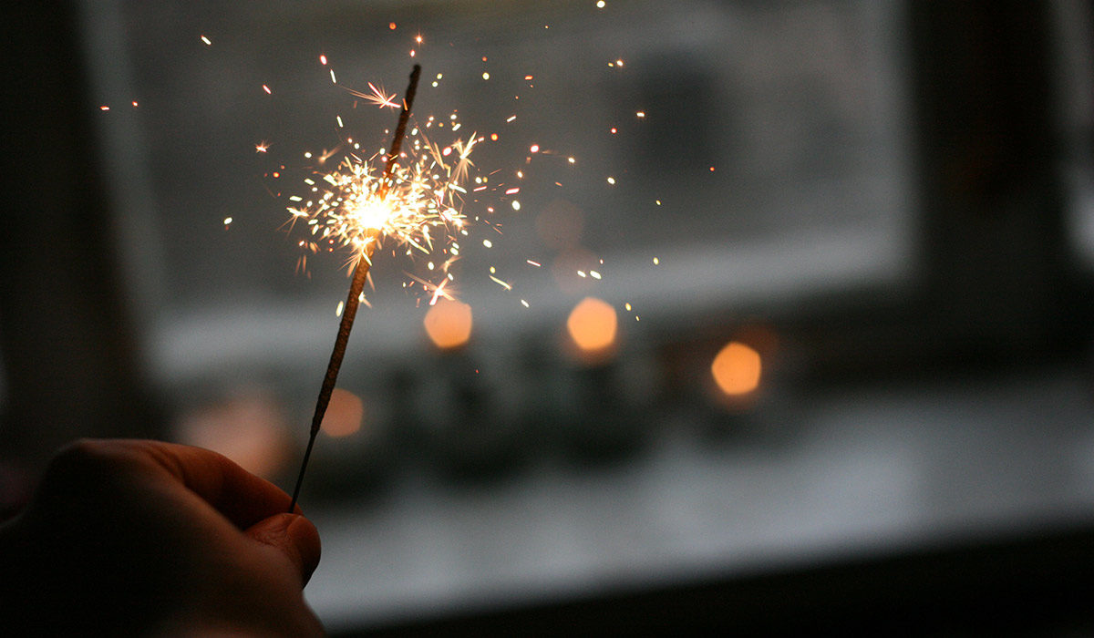 a hand holding a sparkler