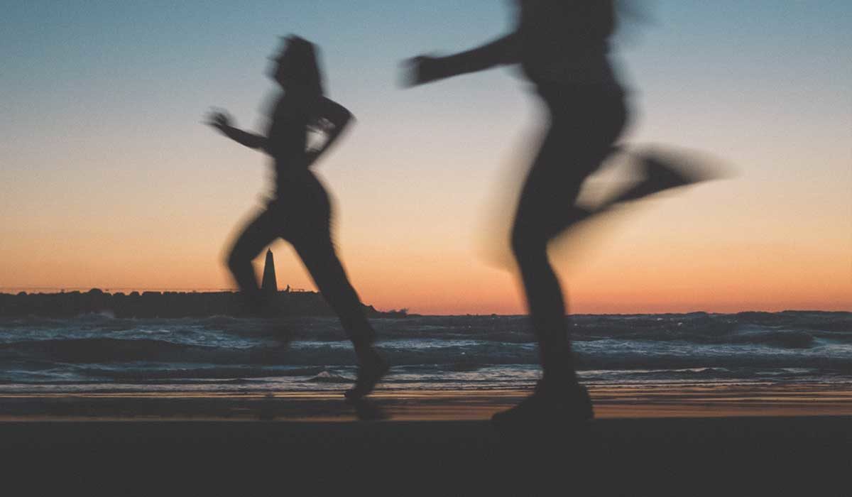 silhouette's running on a beach